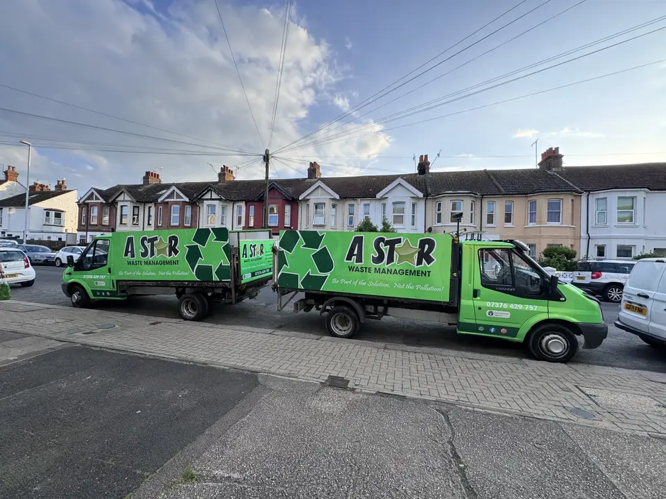 Two A Star Waste Management tipper vans parked on a Sussex street