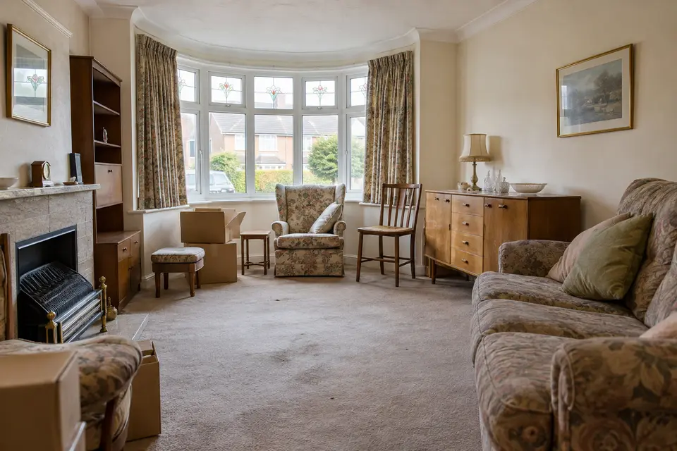 Furnished living room with sofas, a dresser and ornaments ahead of a house clearance
