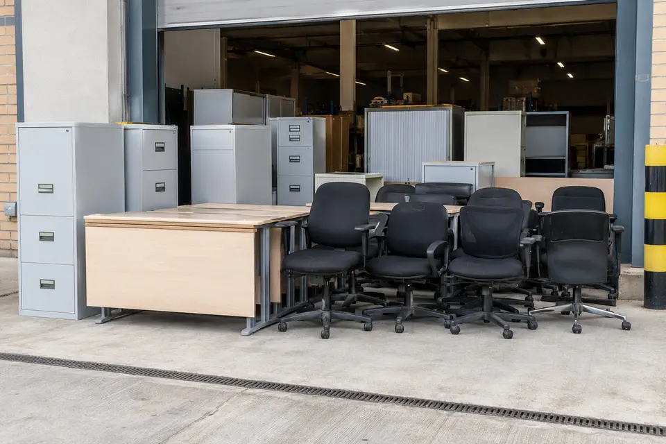 Office chairs, desks and filing cabinets grouped together for clearance