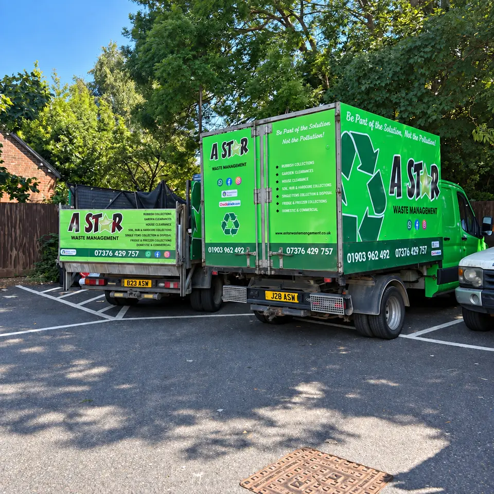 Rear view of two A Star vans showing the green branded tipper bodies