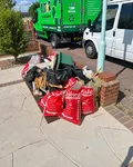 Before: red and black rubbish bags on a driveway with A Star vans parked behind