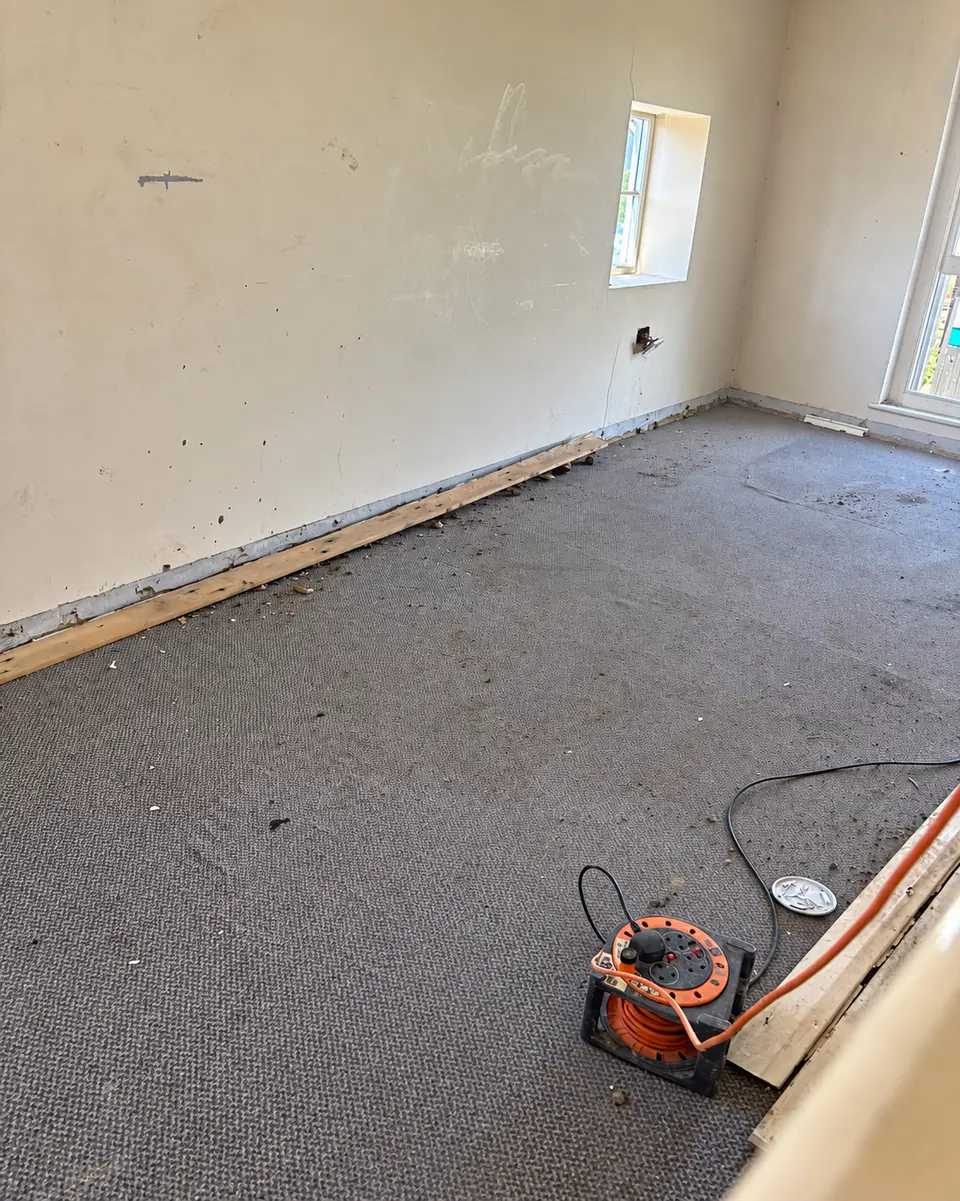 After: the room with all rubble removed and the floor clear