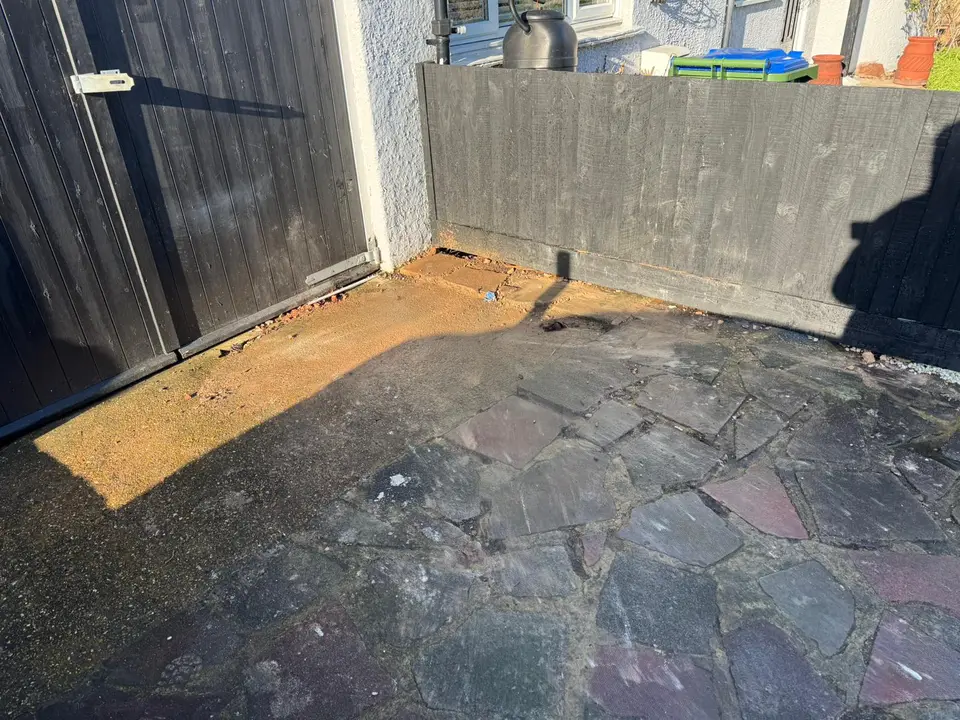 After: the side yard cleared back to bare paving