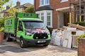 A Star tipper van next to bagged rubble, timber offcuts and renovation waste